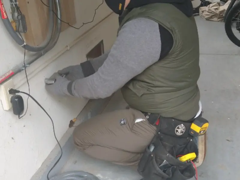 Electrician performing outlet wiring in a Lewisburg garage